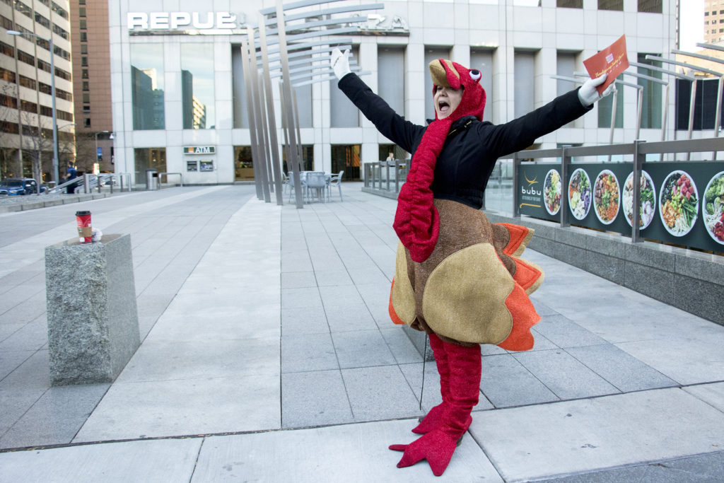 Alexxa Gagner, director of public relations for Denver Rescue Mission, celebrates the first donation of their holiday turkey drive outside of Republic Plaza, Nov. 2, 2018. (Kevin J. Beaty/Denverite)