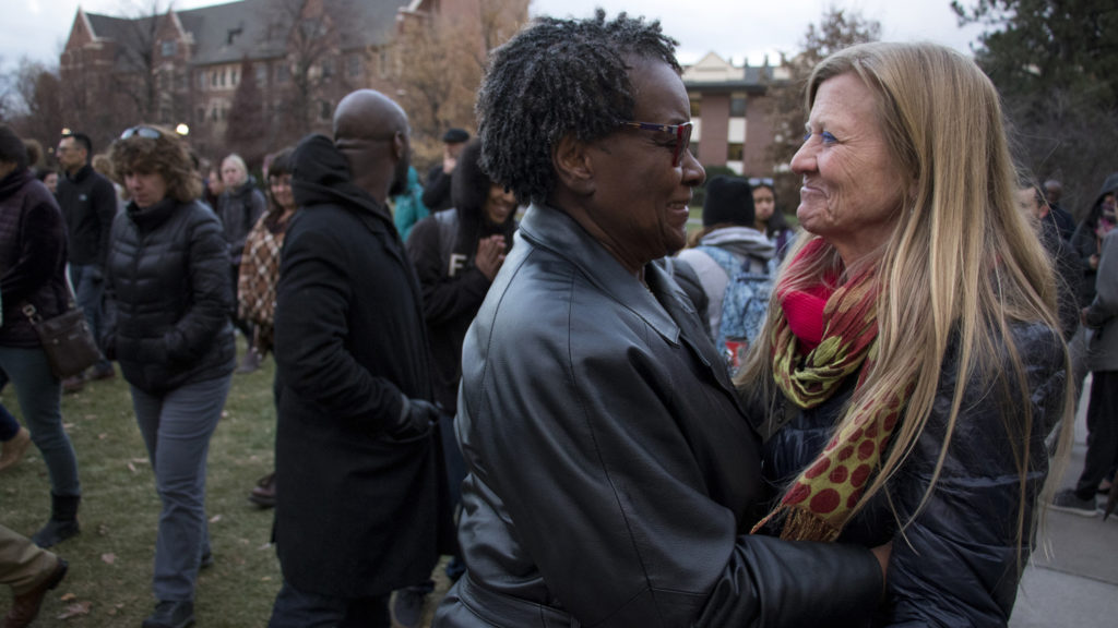 Betsy Hall, assistant dean and professor at Regis University's division of counseling and family therapy, embraces Phyllis Graham-Dickerson after the vigil. Students and faculty at Regis University gather to denounce an incident of hate speech on campus, Nov. 7, 2018. (Kevin J. Beaty/Denverite)