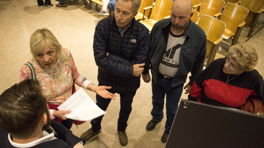 Deb Powers (left) speaks with Kentro Group director of development Chris Viscardi at a community meeting to discuss the future of the old CDOT headquarters in Virginia Village near Colorado Boulevard, Nov. 16, 2018. (Kevin J. Beaty/Denverite)
