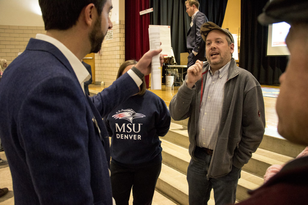 Tim Carl (right) has a heated discussion with CRL Associates partner Sean Malley at a community meeting on the future of the old CDOT headquarters in Virginia Village near Colorado Boulevard, Nov. 16, 2018. (Kevin J. Beaty/Denverite)