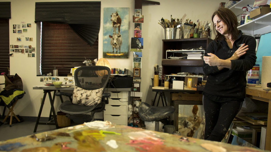 Artist Elsa Sroka speaks to a reporter in her studio at Ironton Distillery and Crafthouse, Five Points, Nov. 28, 2018. (Kevin J. Beaty/Denverite)