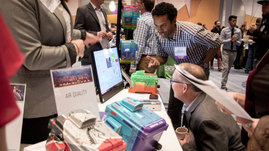 Michael Ogletree, Denver's air quality program manager, shows off a new air quality monitoring system his department is rolling out to local schools. The 2018 Sustainable Denver Summit at the Colorado Convention Center, Nov. 29, 2018. (Kevin J. Beaty/Denverite)