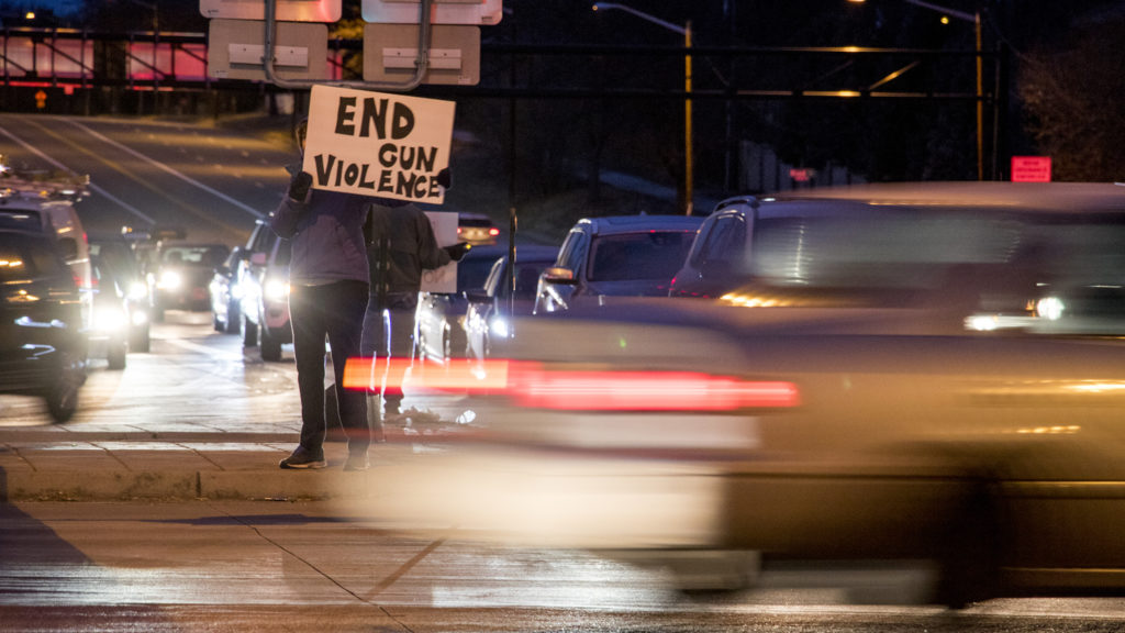 Colorado Faith Communities United Against Gun Violence holds their annual vigil along Hampden Avenue in front of First Plymouth Congregational Church, Dec. 12, 2018. (Kevin J. Beaty/Denverite)
