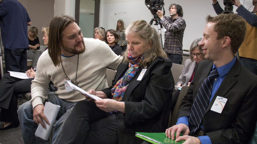 Ean Tafoya embraces Becky English after the Colorado Transportation Commission agreed to a settlement in the third and final lawsuit against the I-70 widening project, Dec. 20, 2018. (Kevin J. Beaty/Denverite)
