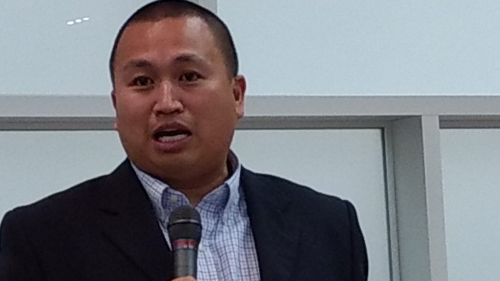 Paolo Diaz, newly appointed poverty reduction & neighborhood outreach manager for Adams County, speaks at the opening of a regional summit on such issues as affordable housing and homelessness. (Donna Bryson/Denverite)