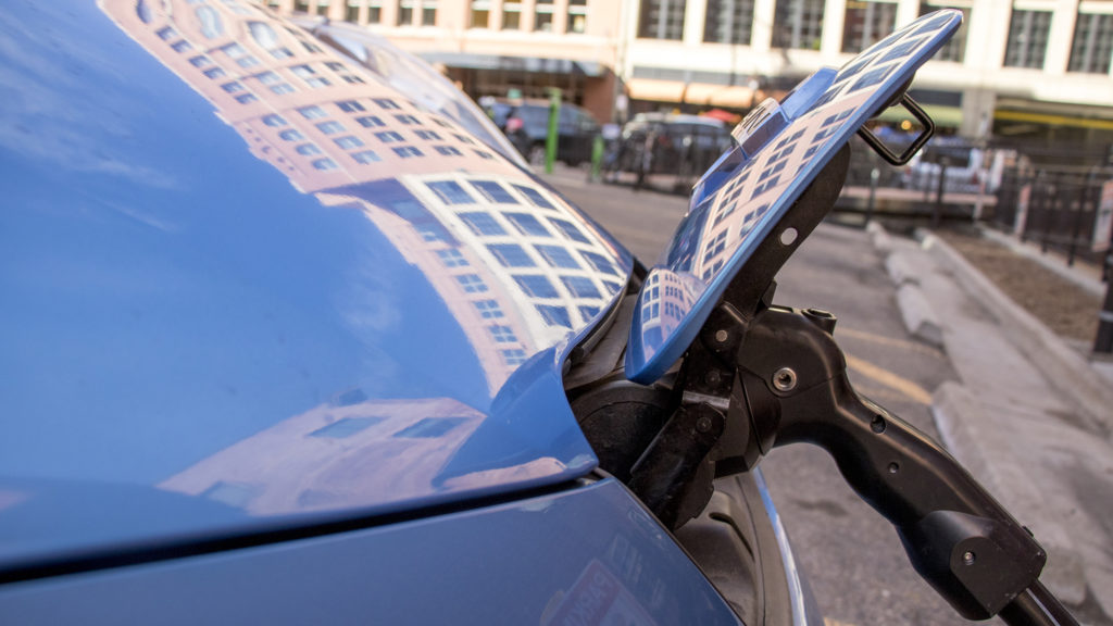 A sneaker-blue electric vehicle charges downtown, Jan. 17, 2019. (Kevin J. Beaty/Denverite)