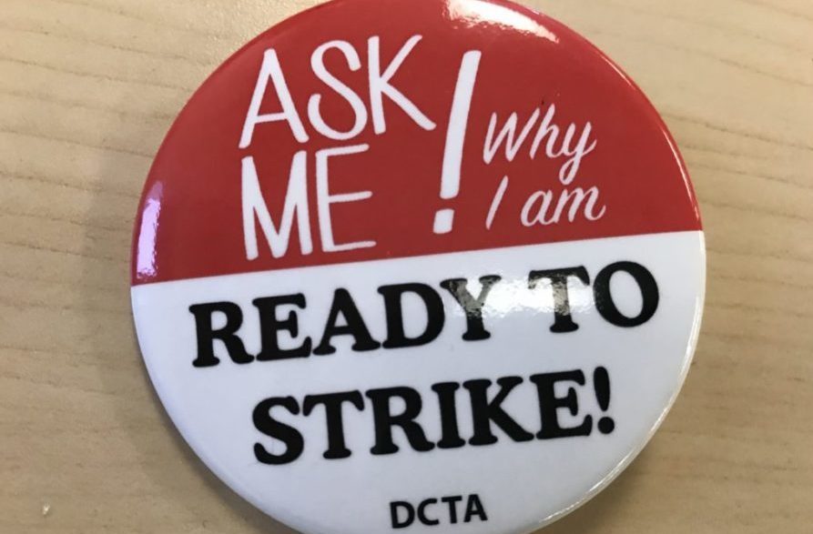 Some Denver teachers are wearing these buttons, provided by the union, at the teacher pay negotiations. (Chalkbeat)