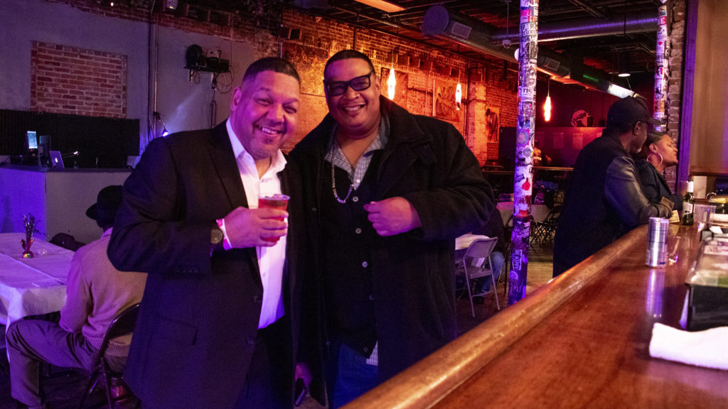 Randall Borne (left) and DJ Sonny P pose for a portrait during a fundraiser for Borne's business at Cervantes' Other Side on Welton Street, Feb. 2, 2019. (Kevin J. Beaty/Denverite)