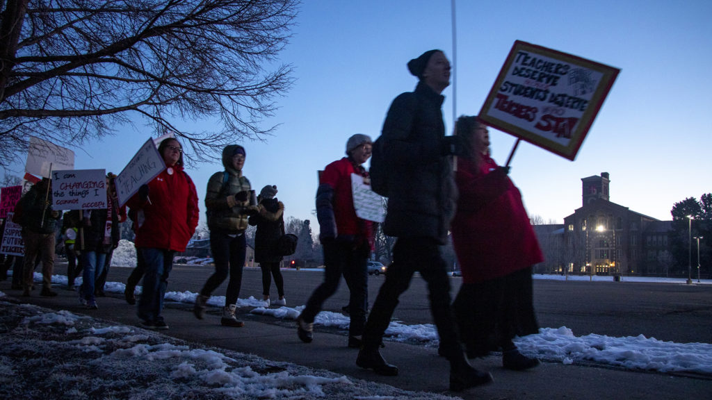 Teachers and supporters march outside of South High School at dawn on the first day of their strike, Feb. 11, 2019. (Kevin J. Beaty/Denverite)