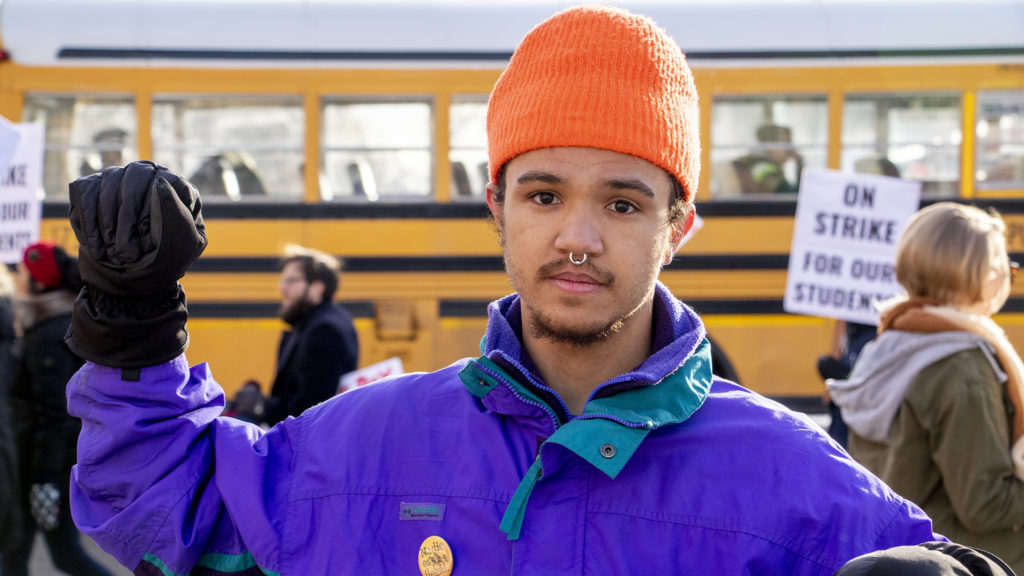 Manasseh Oso, who teaches 9th and 10th grade social studies at Manual High School, poses for a portrait on the picket line. Whittier, Feb. 13, 2019. (Kevin J. Beaty/Denverite)