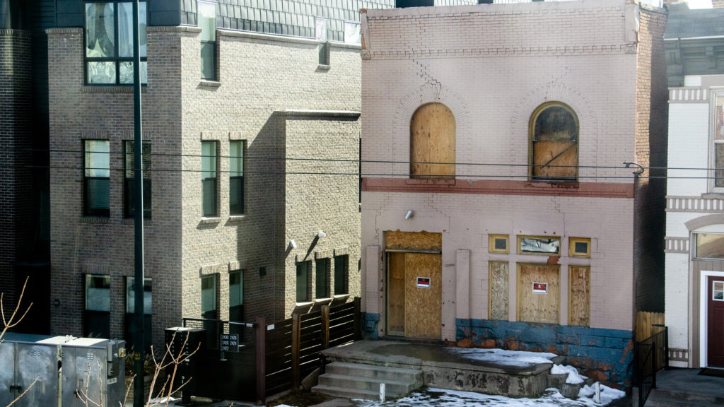 The old Catholic Worker House, seen from inside the Blair-Caldwell African American Research Library, March 1, 2019. (Kevin J. Beaty/Denverite)