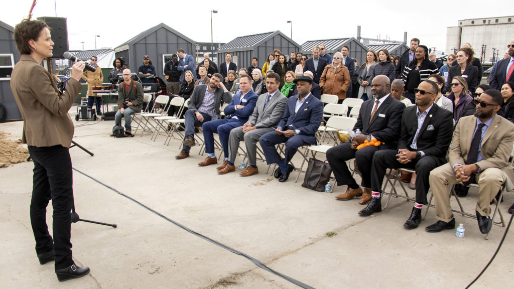 Alison George, with the State Division of Housing, speaks during a groundbreaking ceremony for an affordable housing project at 38th Avenue and Walnut Street, March 21, 2019. (Kevin J. Beaty/Denverite)