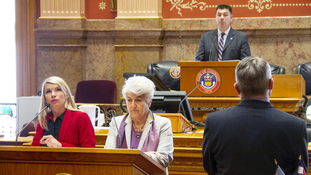 Democratic State Sens. Brittany Pettersen (left) and Lois Court speak in support of the red flag bill as Senate President Leroy Garcia looks on Thursday, March 28, 2019 in the Senate Chambers at the Capitol. In the foreground, Republican state Sen. Christ Holbert, who opposes the bill, watches closely. (Esteban L. Hernandez/Denverite)