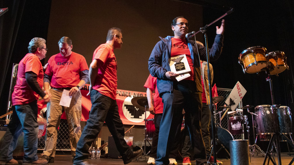 Henry Roman, president of the Denver Classroom Teachers Association, accepts an award on behalf of the union during Denver's annual Cesar Chavez Day celebration, March 30, 2019. (Kevin J. Beaty/Denverite)