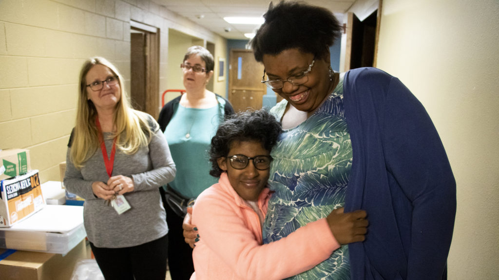 Sarah gives Lexi Ziegler a hug as the Stepping Stone day center moves out of Columbine Hills Church of the Nazarene, Littleton, April 6, 2019. (Kevin J. Beaty/Denverite)