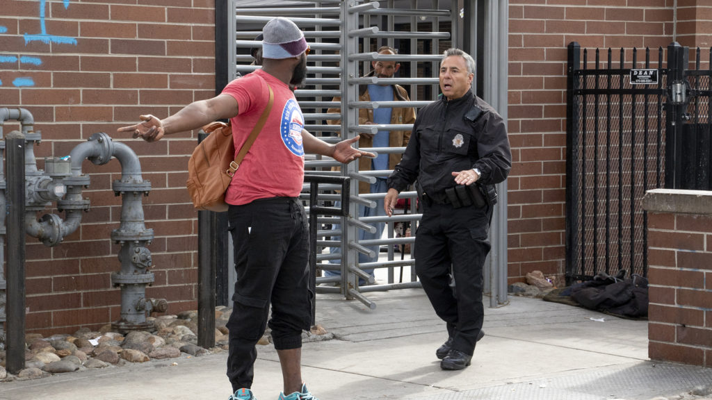 A man named Jeremiah argues with police as the Denver Department of Public Health and Environment cleans up sidewalks near the Denver Rescue Mission, April 17, 2019. (Kevin J. Beaty/Denverite)