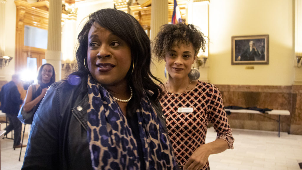 Rep. Leslie Herod and Elisabeth Epps speak to press after Governor Polis signed a bill outlawing cash bail, April 25, 2019. (Kevin J. Beaty/Denverite)