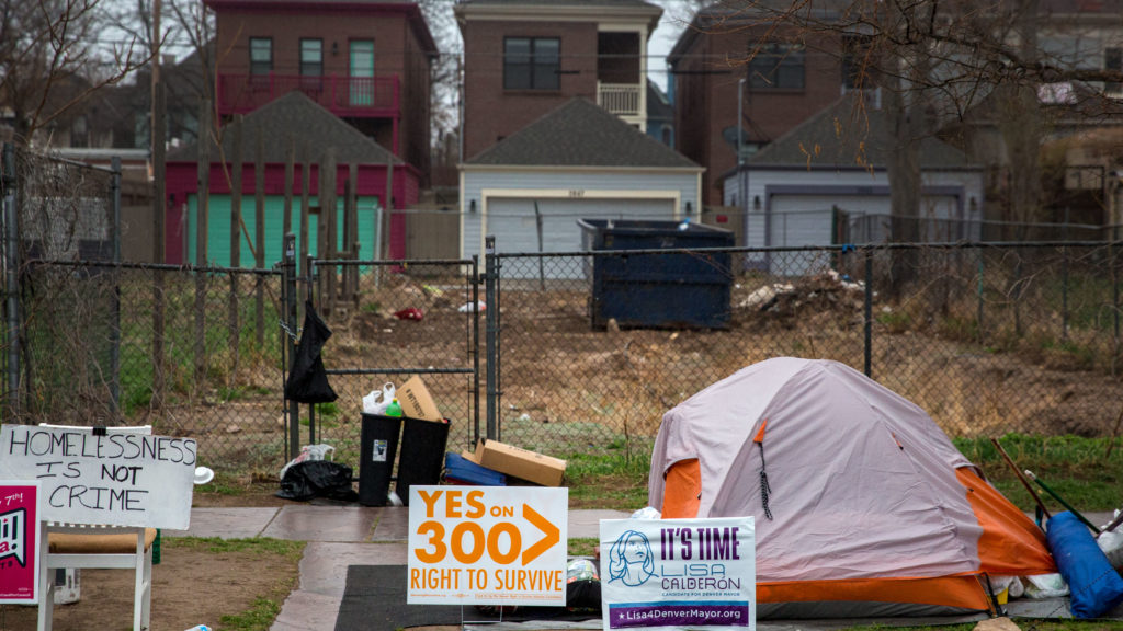 Tents at a homeless camp on Arapahoe at 27th in Denver, with new homes in the background on April 10, 2019. (Hart Van Denburg/CPR News)