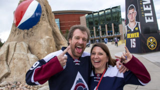 Leslie and Richard Foust, who drove up from Albuquerque to watch the Avalanche game, pose for a portrait outside of the Pepsi Center, May 2, 2019. (Kevin J. Beaty/Denverite)