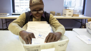 Miguel "Angel" Harlston processes ballots inside Denver Elections Division headquarters on election day, May 7, 2019. (Kevin J. Beaty/Denverite)