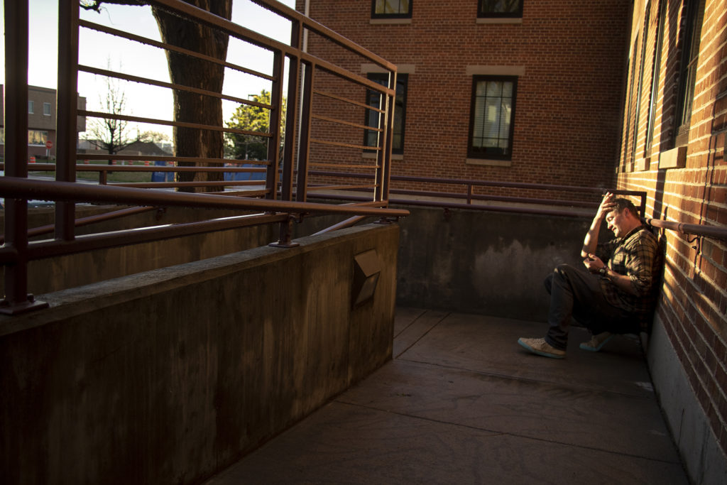 Steel Howard smokes outside a watch party for Initiative 300 after initial results showed the measure was defeated, May 7, 2019. (Kevin J. Beaty/Denverite)