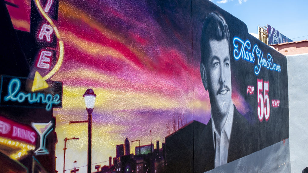 A portrait of Pete Contos on the side of this Satire Lounge on Colfax, May 13, 2019. (Kevin J. Beaty/Denverite)