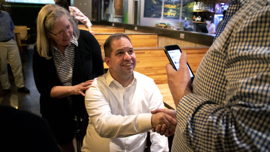 Chris Hinds accepts congratulations after his lead grew over incumbant Wayne New at his election night party, June 4, 2019. (Kevin J. Beaty/Denverite)