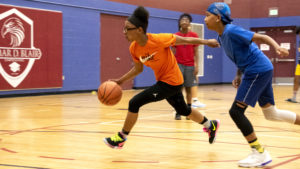 Aniiya (13) makes a drive down a court inside the Green Valley Ranch Recreation Center, June 12, 2019. (Kevin J. Beaty/Denverite)