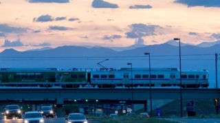 An RTD A Line train crosses Green Valley Ranch Boulevard on its way to Denver International Airport June 12, 2019. (Hart Van Denberg/Denverite)