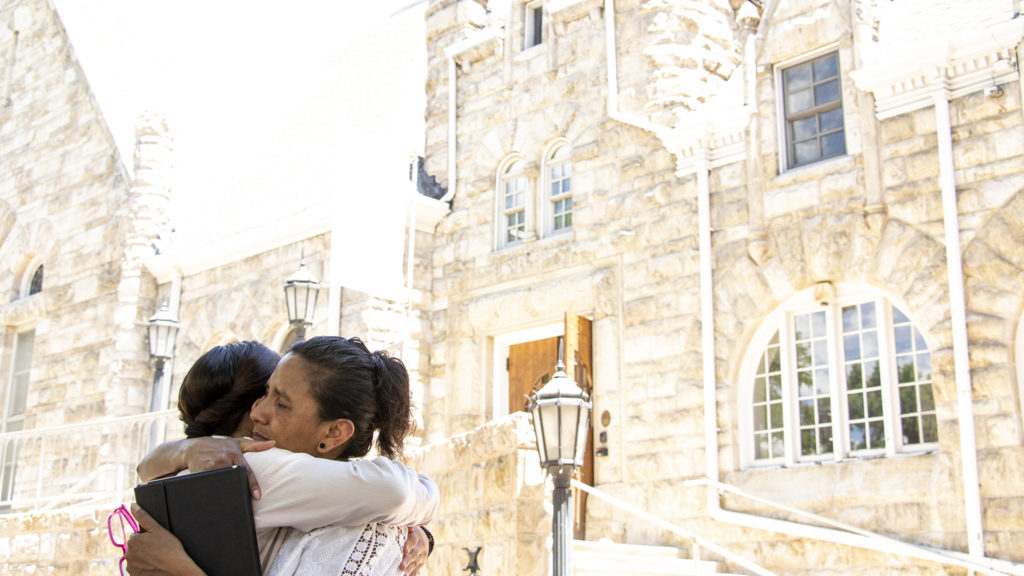 Jeanette Vizguerra hugs Laura Peniche outside of the First Unitarian Society of Denver, where Vizguerra has lived in and out of sanctuary since 2017. June 20, 2019. (Kevin J. Beaty/Denverite)