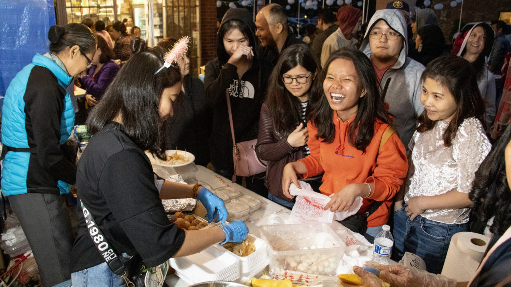 Customers line up for snacks at Troung An Gift's tent at the Little Saigon Night Market along Federal Boulevard, June 21, 2019. (Kevin J. Beaty/Denverite)