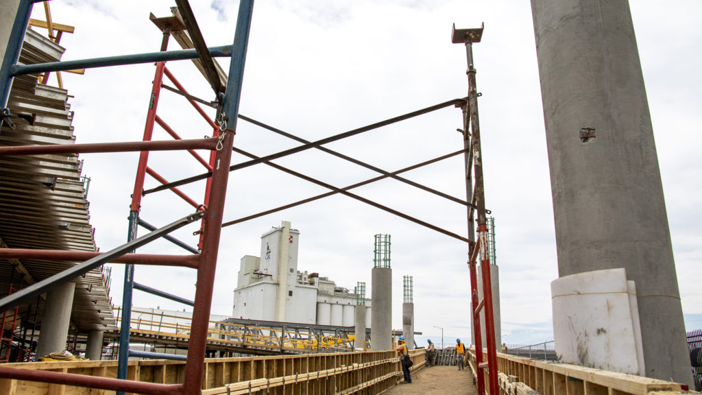 Work on a new pedestrian bridge spanning the York Street railroad crossing in Elyria Swansea, June 27, 2019. (Kevin J. Beaty/Denverite)