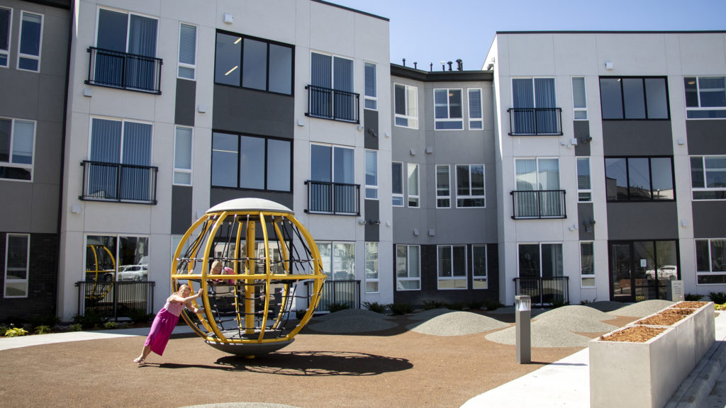 Kids play on a playground outside the Moline Apartments in Stapleton, July 19, 2019. (Kevin J. Beaty/Denverite)