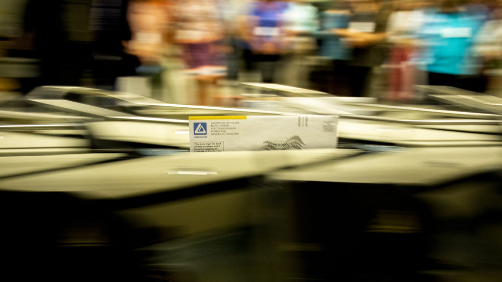 A ballot flies through a verifier machine at a Jefferson County elections facilty in Golden, July 1, 2019. (Kevin J. Beaty/Denverite)