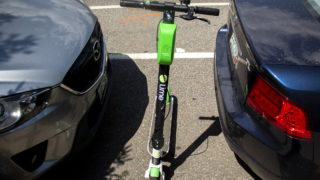 A Lime scooter parked in a parking spot, Aug. 6, 2019. (Kevin J. Beaty/Denverite)