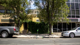 A Lime scooter parked in a parking spot, Aug. 6, 2019. (Kevin J. Beaty/Denverite)