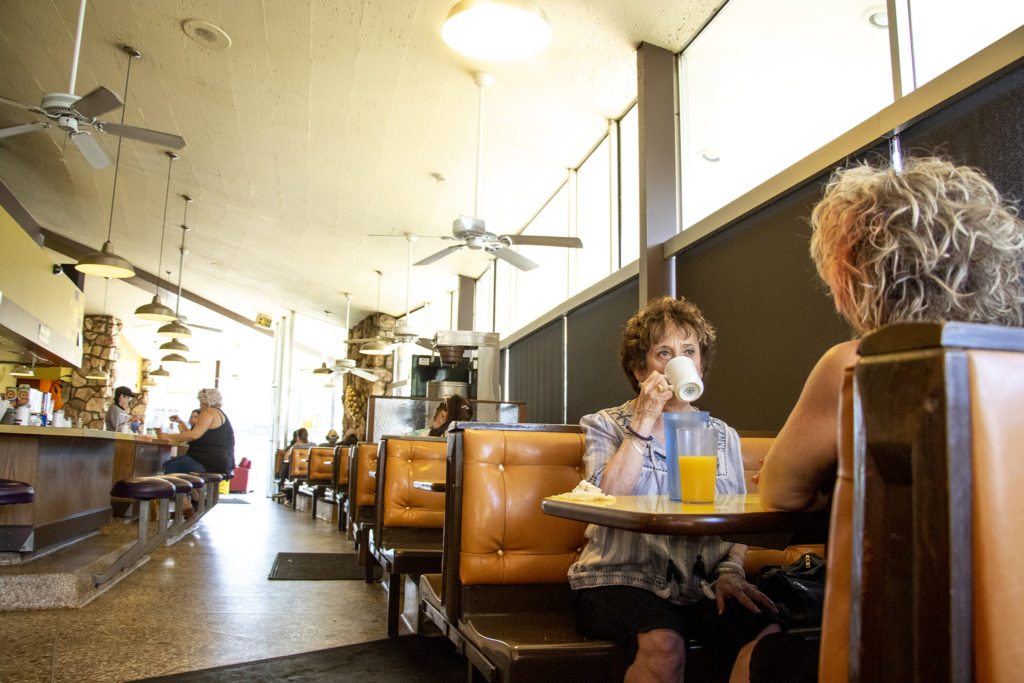 Barbara Dey and Debra Fawcett finish up coffee at Tom's Diner on East Colfax Avenue. North Capitol Hill, Aug. 15, 2019. (Kevin J. Beaty/Denverite)