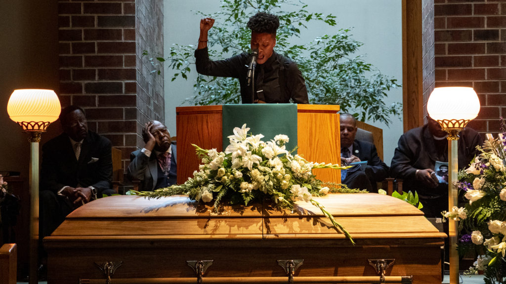 Kerrie Joy reads a poem to open a funeral for Lauren Watson, founder of Colorado's Black Panther Party, Aug. 21, 2019. (Kevin J. Beaty/Denverite)