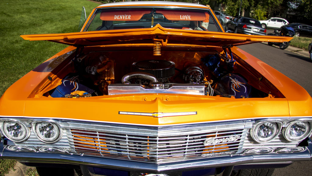Mikey Bartolo's Denver-themed low rider is parked at Barnum Park after a cruise down Federal Boulevard. Aug. 25, 2019. (Kevin J. Beaty/Denverite)
