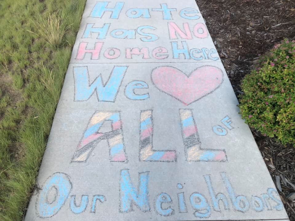 Positive messages drawn in chalk near an area where racist graffiti was found at Prairie Meadows Park in Stapleton last week. (Courtesy Melissa West)