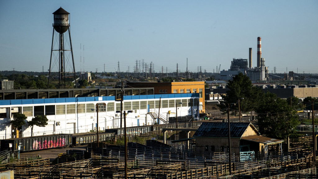 The National Western complex and Xcel Energy's Cherokee Generating Station seen from the historic Denver Union Stock Yard Exchange Building, Sept. 12, 2019. (Kevin J. Beaty/Denverite)