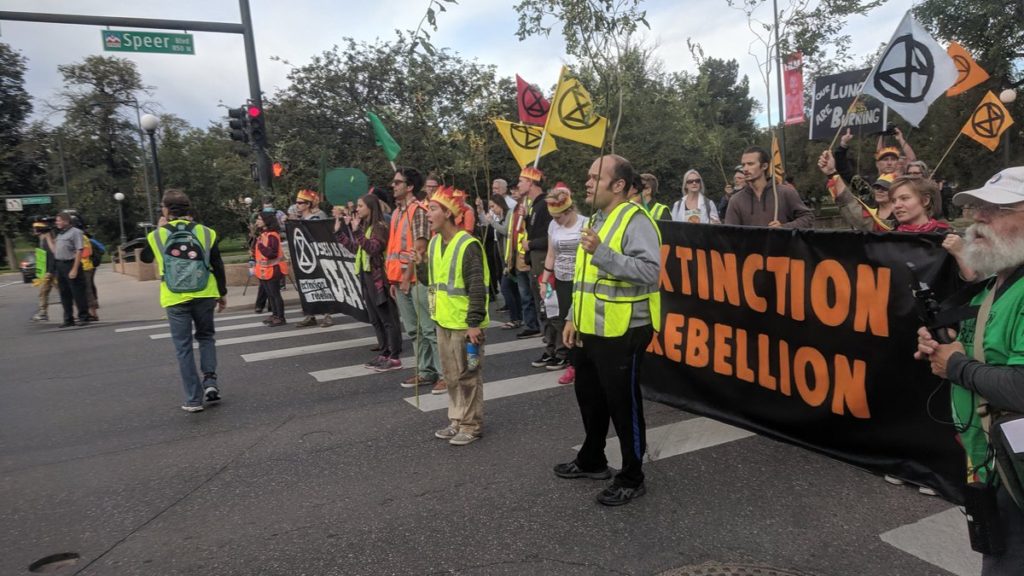 Protesters with Extinction Rebellion Denver block Spear Boulevard, Monday September 23, 2019. (Sam Brasch/CPR News)