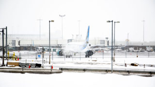 A Frontier plane pulls away from a gate at Denver International Airport on a very snowy day. Oct. 29, 2019.