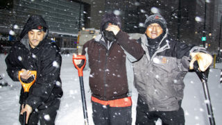 Sidewalk shovelers Mario Favela (left to right), T. and Orlando Alonzo pose for a portrait downtown on snowy day. Oct. 29, 2019. (Kevin J. Beaty/Denverite)