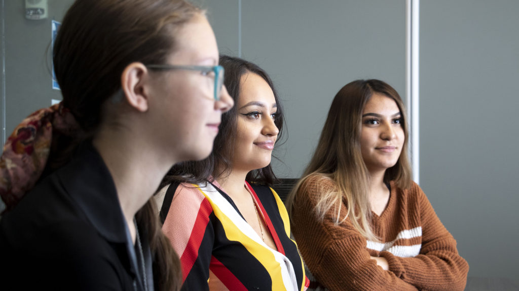 Amanda Coy (left to right), Bryssa Silerio and Elena Espino, North Denver Cornerstone Collaborative interns, speak to a reporter in their office, Oct. 30, 2019. (Kevin J. Beaty/Denverite)