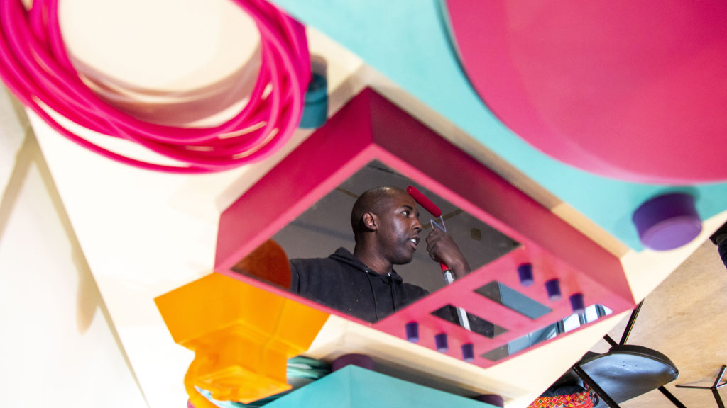 Thomas "Detour" Evans speaks to a reporter during the installation of his "5 Pointers Museum" at the Redline Contemporary Art Center, Oct. 31, 2019. (Kevin J. Beaty/Denverite)