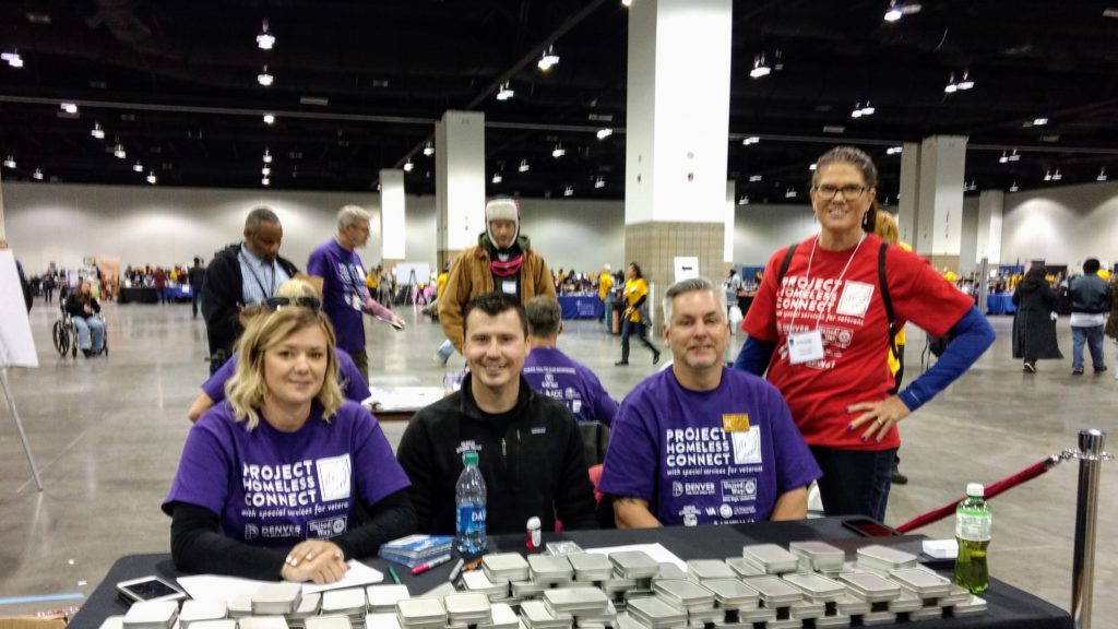 From left to right, Brandy Morrison of the VA health care system; Rob Bingham of the Colorado Veterans Project, Matthew Dixon-Moran of VFW Post 2461 and Khristie Barker of the VA at Project Homeless Connect Denver on Oct. 10, 2019. (Donna Bryson/Denverite)