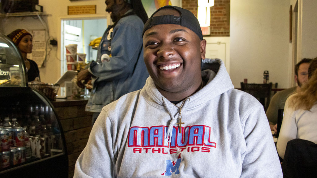 Tay Anderson, the newly elected at-large member of Denver's school board, speaks with a reporter at Whittier Cafe. Nov. 6, 2019. (Kevin J. Beaty/Denverite)