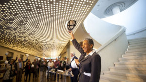 Denver Deputy Mayor Allegra "Happy" Haynes ceremoniously removes her hard hat as Denver Art Museum officials celebrate the end of their new Martin Building's construction phase and the start of their "museum making" stage. Nov 13, 2019. (Kevin J. Beaty/Denverite)