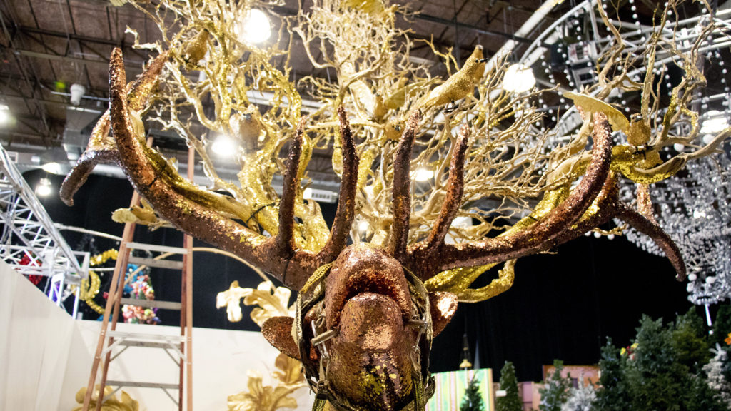 Here is a shiny elk. Lonnie Hanzon's "Camp Christmas" is under construction at Stanley Marketplace. Nov. 15, 2019. (Kevin J. Beaty/Denverite)